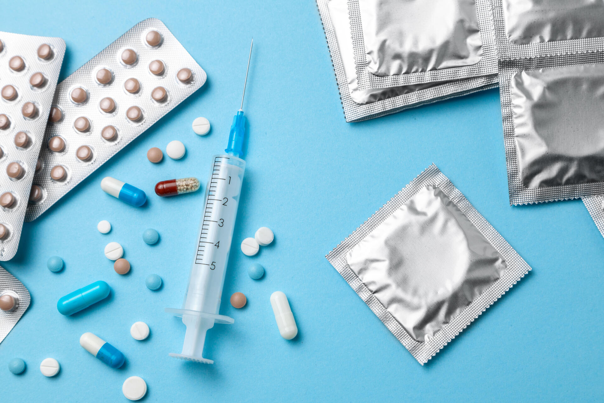 Selection of Sexual Health Supplies including pills, syringes and condoms.